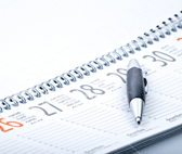 Pen resting on a calendar.
